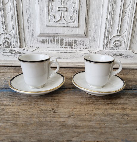 Pair of small French café brûlot cups in heavy iron porcelain decorated with black and gold from A.Pillivuyt