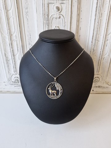 Necklace and pendant in silver, the pendant is designed as a forest with deer